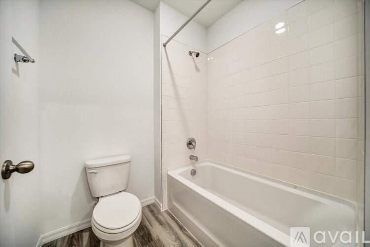 A white toilet is next to a bathtub in a bathroom.