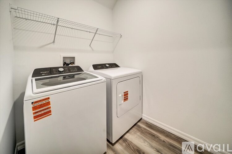 A washing machine and dryer in a laundry room.