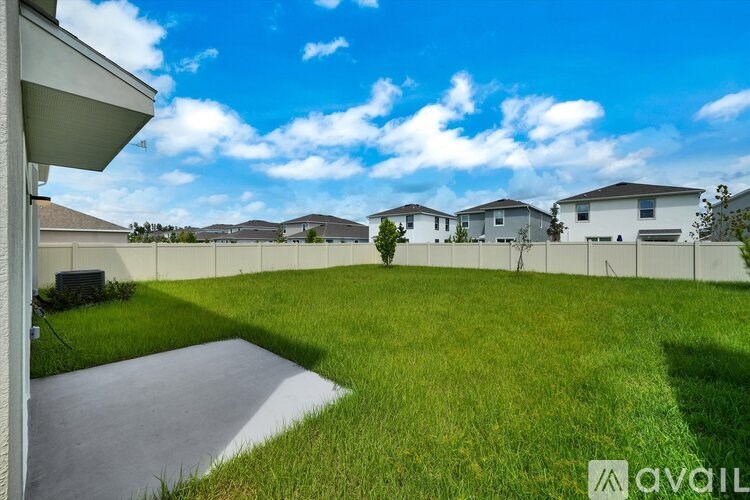 A sunny day in a residential area with houses and a clear sky.
