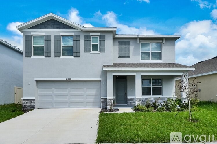 A two-story house with a garage is for sale.