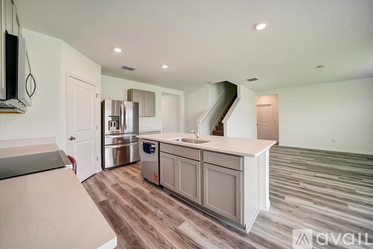 A kitchen with a stainless steel refrigerator, a stainless steel oven, and a stainless steel dishwasher.