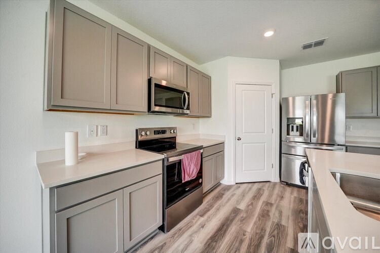 A kitchen with brown cabinets and a white countertop.