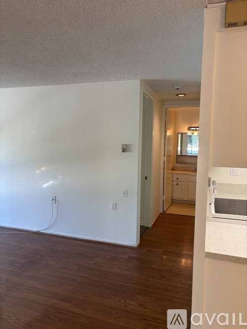 A room with wooden floors and white walls.
