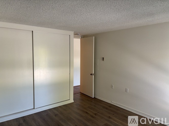 A room with a white wall and a white door.