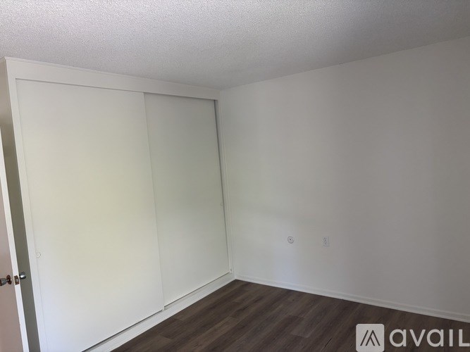 A room with a sliding door and wooden flooring.