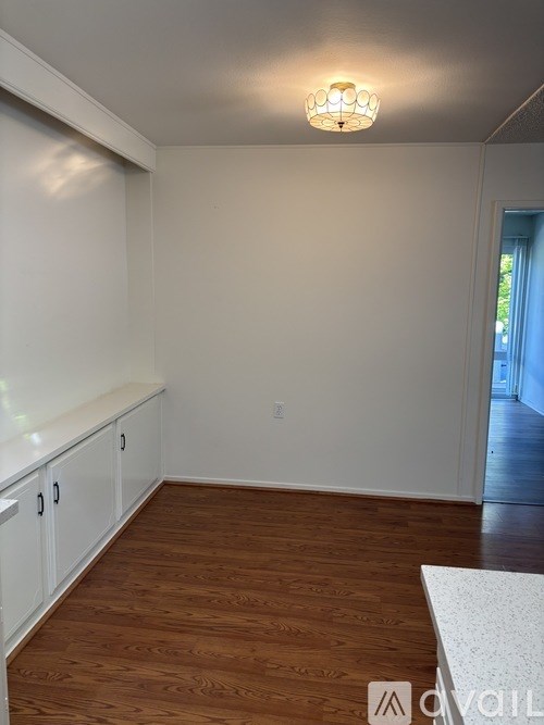 A room with wooden floors and white walls.