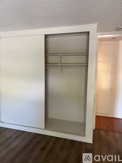 A white cabinet with a glass door is open.