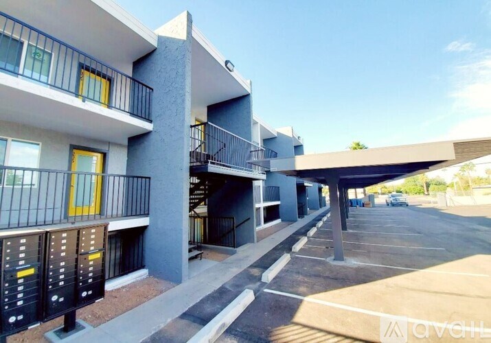 A modern apartment complex with a parking lot in front.