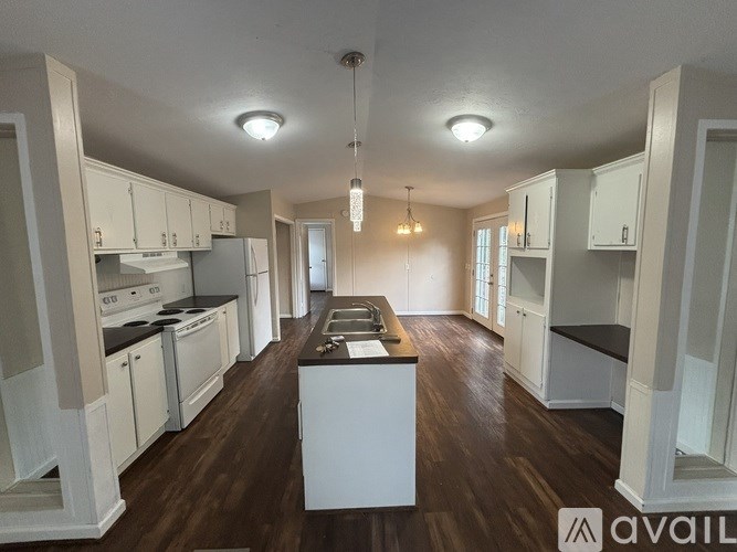 A room with a ceiling fan and three doors.
