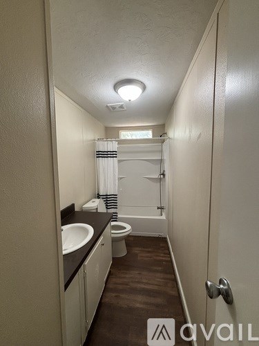 A bathroom with a sink, toilet, and bathtub.