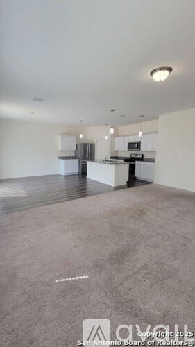 Empty room with grey carpet and white walls.