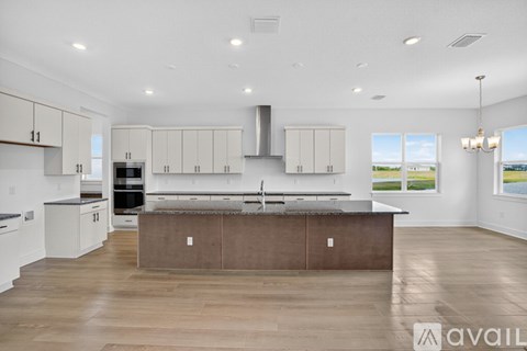 A modern kitchen with a large island in the center.