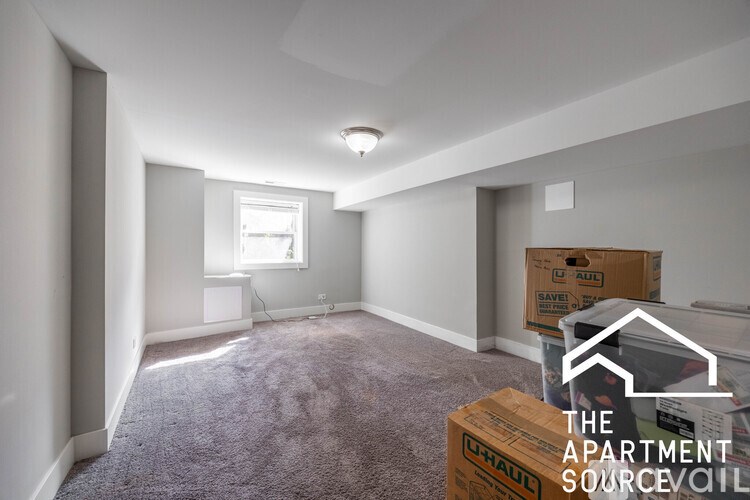 Apartment sourcevail logo on a room with boxes and carpet.