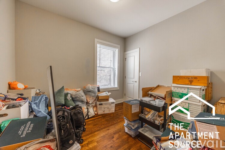 A room with a lot of boxes and items scattered around.