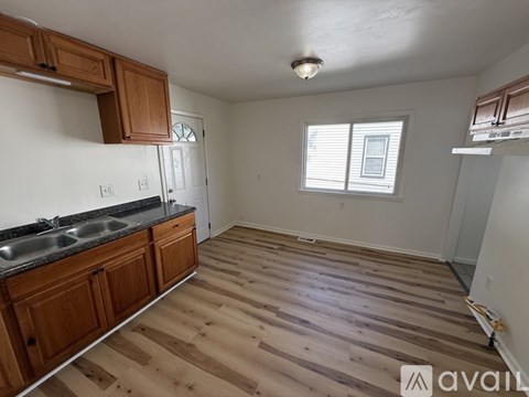 A kitchen with wooden cabinets and a black countertop.