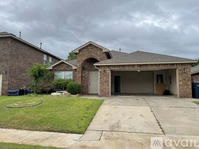 A house with a garage and a driveway is available for sale.