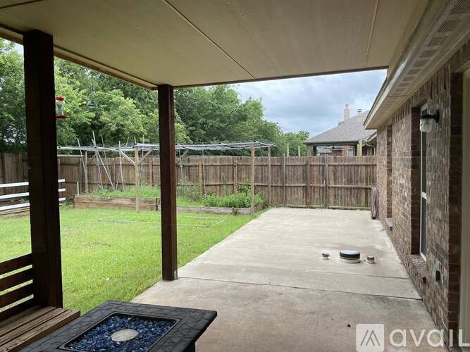A patio area with a table and chairs is visible through a covered doorway.