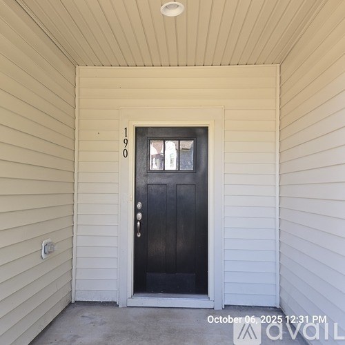 A black door with the number 1909 on the wall above it.