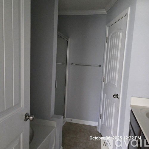 A bathroom with a white door and a white sink.