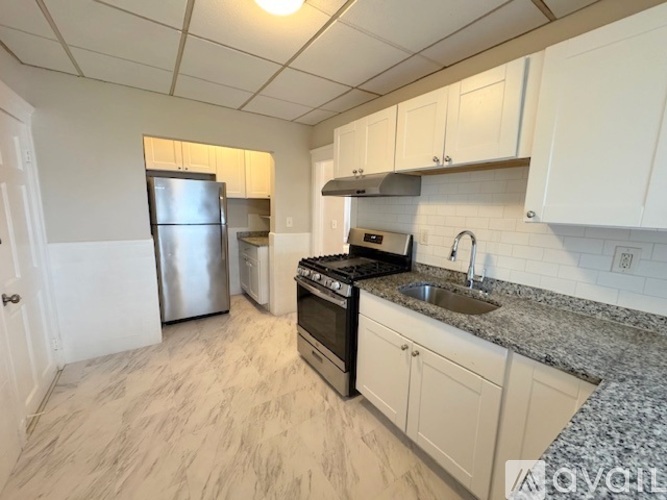 A kitchen with granite countertops and stainless steel appliances.