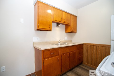 A kitchen with wooden cabinets and a white countertop.