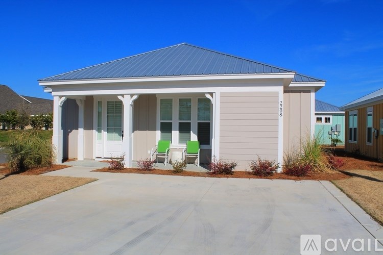 A house with a blue roof and white columns is available for sale.