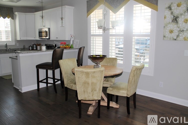 A kitchen with a table and chairs in the foreground.