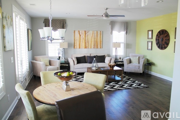 A living room with a wooden table and chairs.
