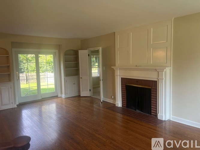 A living room with a fireplace and sliding glass doors.