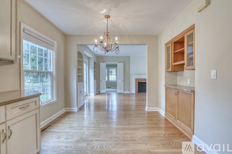 A room with a sliding glass door leading to a backyard.