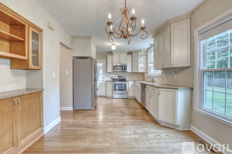 A kitchen with wooden cabinets and a granite countertop.