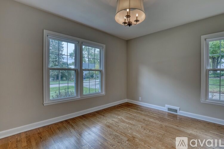 A room with a white door and a window.