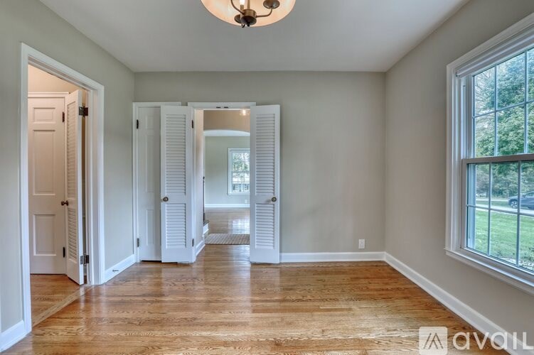 A room with a wooden floor and a ceiling fan.
