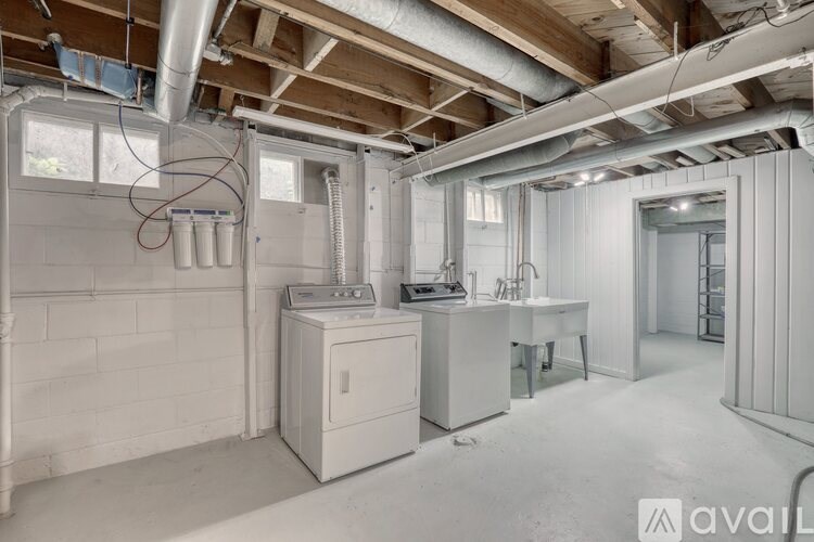 A room with a white cabinet and a table with chairs in it.