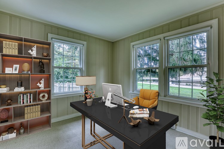 A room with a chandelier, two windows, and a wooden floor.