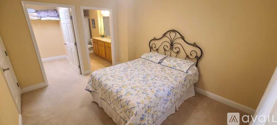 A bedroom with a bed and a dresser is shown.