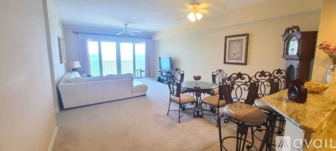 A living room with a white couch and a television.