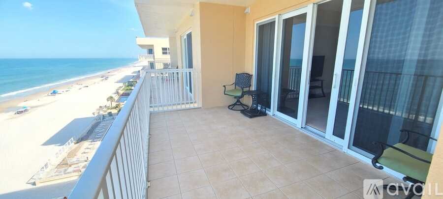 A balcony with a view of the beach.