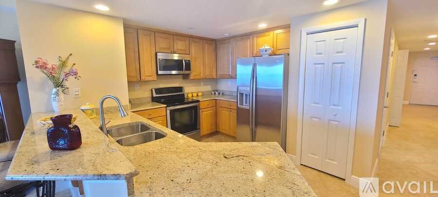 A kitchen with granite countertops and stainless steel appliances.