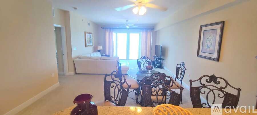 A living room with a white sofa and a television.