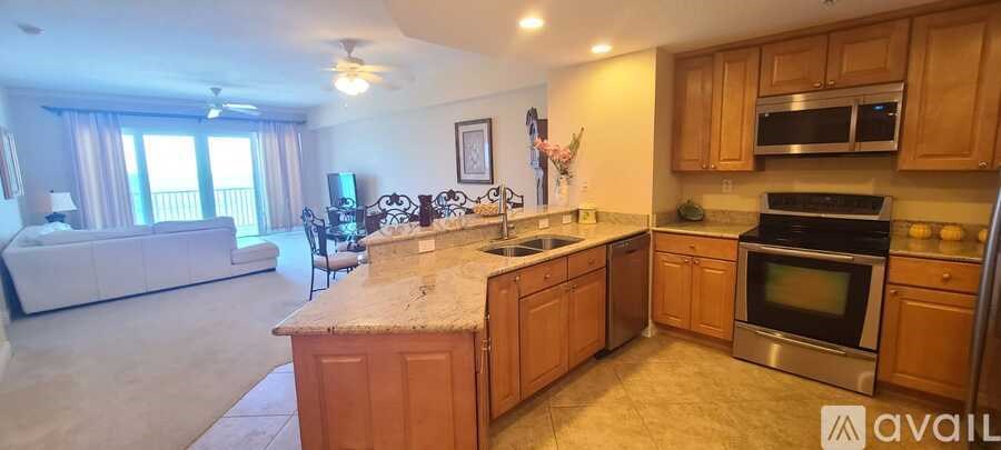 A kitchen with wooden cabinets and a granite countertop.