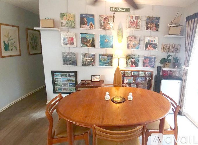 A dining room with a wooden table and chairs.