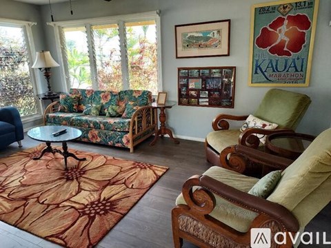 A living room with a floral rug and a couch with a floral pattern.