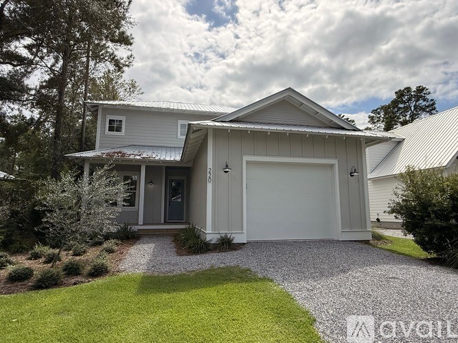 A house with a grey roof and a white garage door.