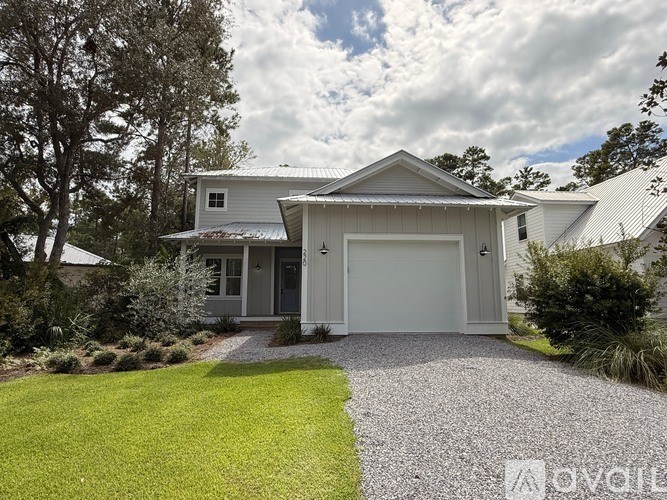 A house with a grey roof and a white garage door.