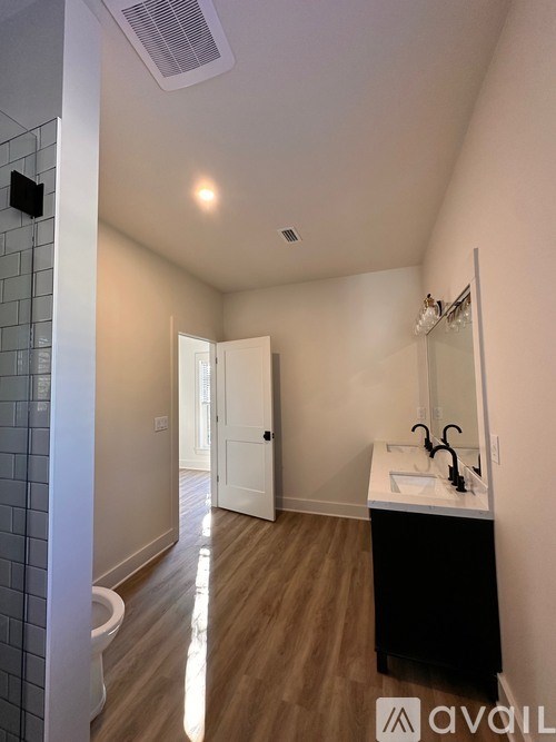 A bathroom with a sink, mirror, and toilet.