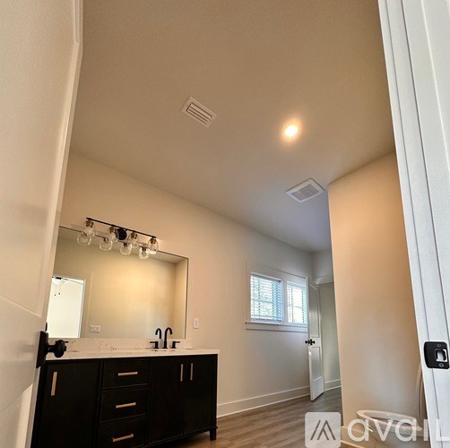 A bathroom with a vanity and a mirror.