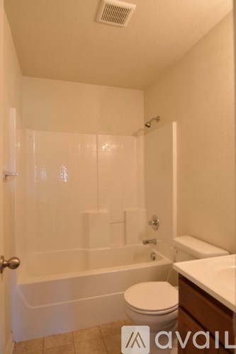A bathroom with a toilet, sink, and bathtub.