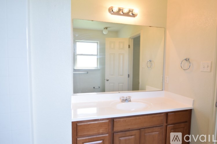 A bathroom with a sink and mirror.