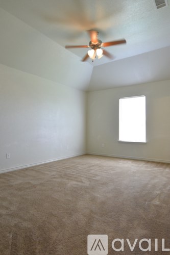 A room with a ceiling fan and a window.